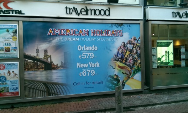 Window graphic at Travelmood shop showing dream deals to America
