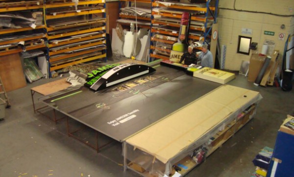 bespoke solution created for Jameson shown before it was finished and displayed shown beside two people