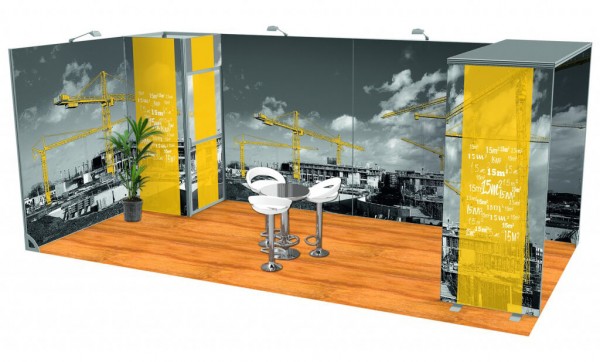 Modular exhibitions display with fabric walls depicting yellow cranes towering over black and white buildings