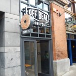 Full image of offbeat donut signage facing onto street