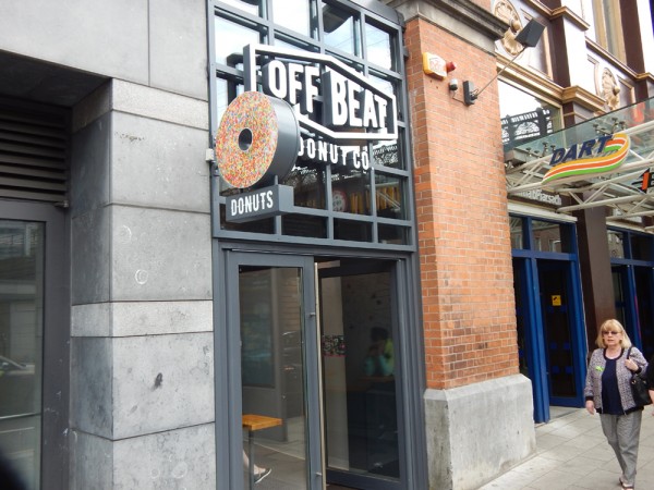 Full image of offbeat donut signage facing onto street