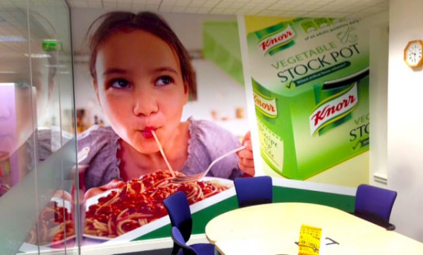 Wall graphic in a meeting room depicting a child enjoying a meal