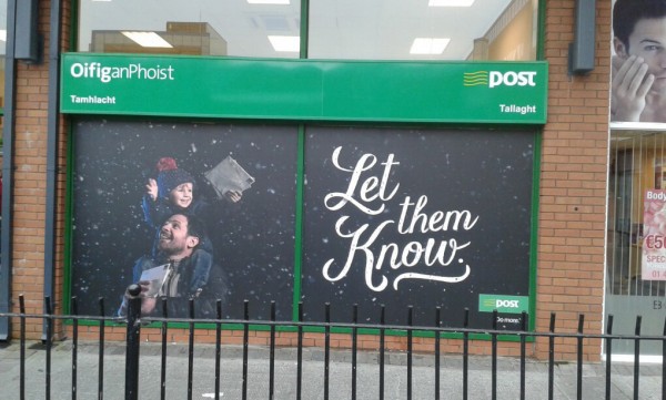 Window Graphic at An Post in Tallaght showing a happy son on his father's shoulders